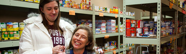 2 happy women in a food pantry